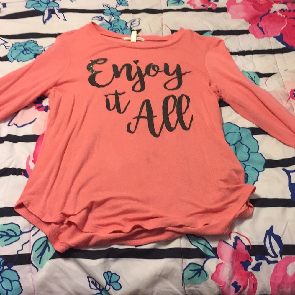I am selling a pink shirt that says Enjoy it all.